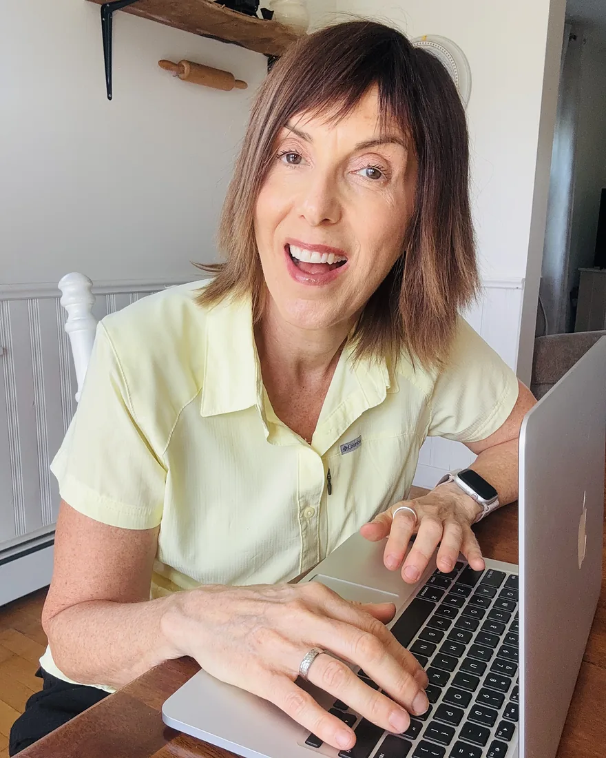 Kris Ward at her laptop, building a business that runs without you